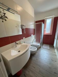 a bathroom with a white sink and a toilet at appartamentsandreis in Malcesine
