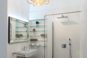 a bathroom with a sink and a mirror at Luksuzni apartmaji v centru Portoroža z vrtom in parkiriščem - Luxury Apartments in Portoroz Center with Garden & Parking in Portorož +45 photos