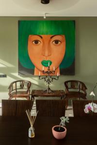 a large painting of a woman with green lipstick at Private beach Oceanfront 3bd Villa in Cemagi