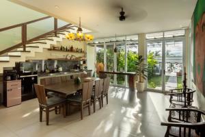 a kitchen and dining room with a table and chairs at Private beach Oceanfront 3bd Villa in Cemagi