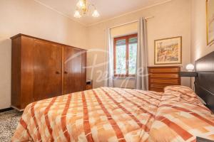 a bedroom with a bed and a dresser and a window at Villa Elena in Portovenere
