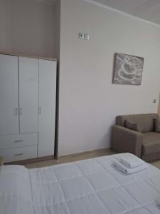a living room with a bed and a couch at Studio Panos 2 in Mytilene