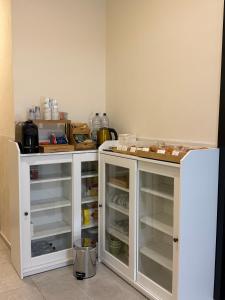 a kitchen with white cabinets and a refrigerator at La Locanda del Giardino in Lentate sul Seveso