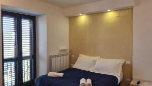 a bedroom with a bed with two pairs of shoes on it at B&B In Sabina in Poggio Nativo +45 photos