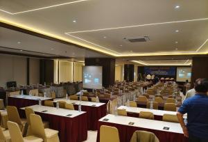 a large room with tables and chairs and people in it at PIA Hotel Bandung in Bandung