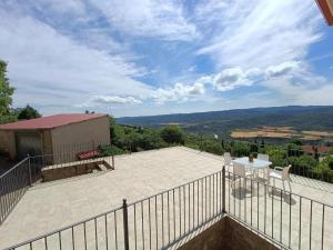 a patio with a fence and a table and chairs at FIGONERO 4-6 in Las Peñas de Riglos