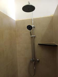 a shower with a shower head in a bathroom at Jasmin Garden in Kalutara
