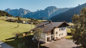 an aerial view of a house with mountains in the background at Unterwötzlhof in Abtenau