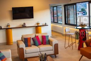 a living room with a couch and a tv at Hotel Mitru in Tupiza