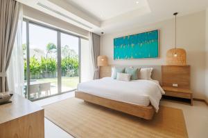 a bedroom with a large bed and a large window at Trichada Essence in Ban Pak Lak +21 photos