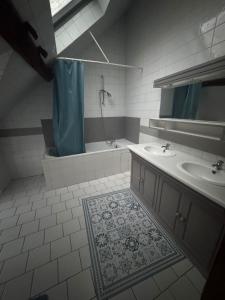 a bathroom with two sinks and a tub and a shower at Le Caillou in Reuilly +37 photos