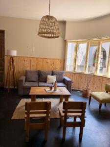 a living room with a couch and a table at Casa Josefina Hotel Boutique in Olavarría