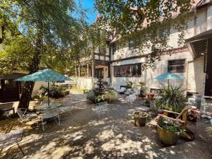 a patio with tables and chairs and an umbrella at Cecil Bacon Manor in Seattle