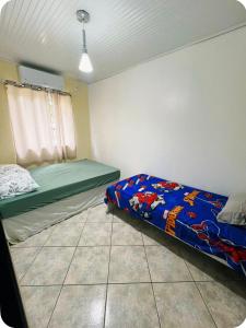 a small bedroom with a bed and a window at Casa completa com lareira, piscina compartilhada in Torres +10 photos