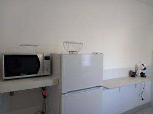 a microwave sitting on top of a counter next to a table at Casa Vallati in Scardovari +2 photos