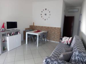 a living room with a couch and a table with chairs at Casa Vallati in Scardovari