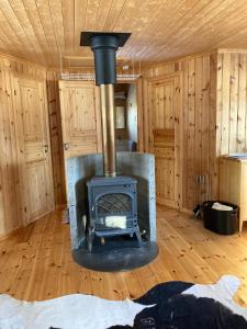 a wood stove in a room in a cabin at Cabin in Tydal, enjoy! in Tydal