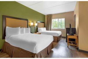 a hotel room with two beds and a television at Studio 6 Extended Stay Fishkill Route 9 NY in Fishkill