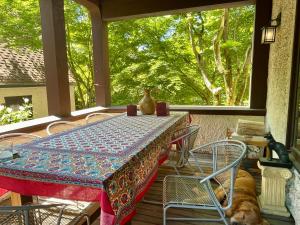 a table and chairs on a porch with a dog at Cecil Bacon Manor in Seattle