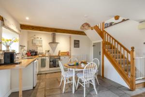 a kitchen and dining room with a table and chairs at 1 Bed in Taunton oc-bartc in West Monkton