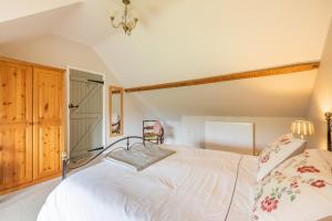 a bedroom with a white bed and a chair at 1 Bed in Taunton oc-bartc in West Monkton