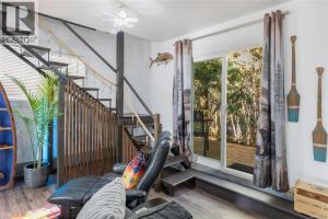 a living room with a couch and a window at Nesting Ravens cottage in Nanaimo