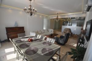 a living room with a dining table and a couch at Villa Port Bodrum in Bodrum City