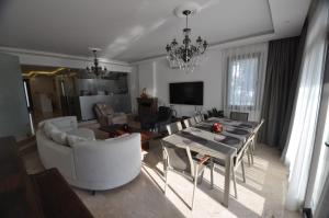 a living room with a table and a dining room at Villa Port Bodrum in Bodrum City