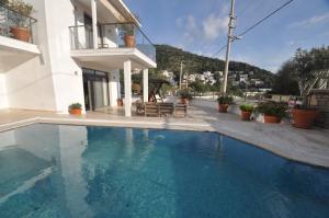 a swimming pool in front of a house at Villa Port Bodrum in Bodrum City