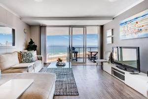a living room with a view of the ocean at Cape Town, Blouberg Beachfront Luxury Apt - Kite Beach in Bloubergstrand
