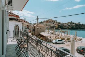 a balcony of a house with a view of the water at Teal Seafront Home in Syvota