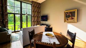 a dining room with a table and a large window at Lossipark Guest Apartments - vis-à-vis Bishop's Castle in Haapsalu