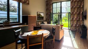 a kitchen and dining room with a table and chairs at Lossipark Guest Apartments - vis-à-vis Bishop's Castle in Haapsalu