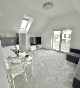 a living room with a table and a tv at Apartman Amanda - Ohrada in Choťánky