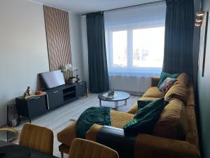 a living room with a couch and a tv at Andrelle Rental in Tõrvandi