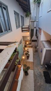 an apartment with a courtyard with potted plants in a building at Casa Vila Mar Guesthouse in Guaratuba