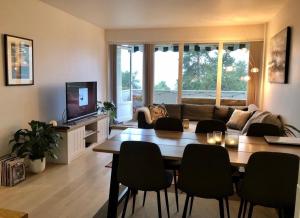 a living room with a table and a couch at Apartment with a view at Tonsenhagen in Oslo