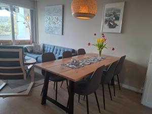 a dining room with a wooden table and chairs at Apartment with a view at Tonsenhagen in Oslo