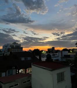 a view of a city at sunset with buildings at Inehouse in Concepción del Uruguay