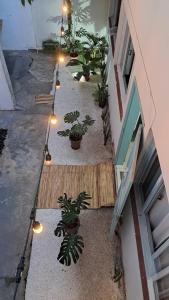 a courtyard with potted plants and lights next to a building at Casa Vila Mar Guesthouse in Guaratuba