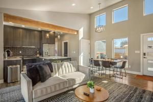 a living room with a couch and a kitchen at Timber & Tin G 2Bed 2Bath w Pool & Rooftop Deck in Kanab