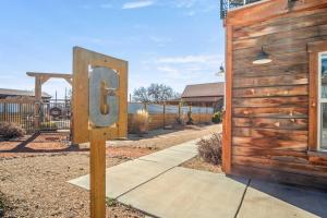 a sign that says g in front of a house at Timber & Tin G 2Bed 2Bath w Pool & Rooftop Deck in Kanab