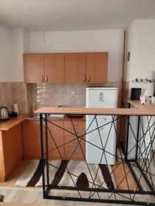 a kitchen with a table in the middle of it at LOBO stan na dan in Lukavica +5 photos