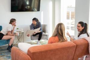 a group of people sitting in a living room at Timber & Tin G 2Bed 2Bath w Pool & Rooftop Deck in Kanab