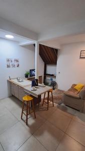 a living room with a table and a couch at Casa Vila Mar Guesthouse in Guaratuba