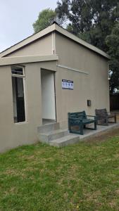 a building with two benches in front of it at Morgenzon Lodge in Morgenzon +60 photos