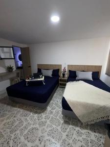 a bedroom with two beds and a table in it at Loft 4 Bambú in Laureles Stadium in Medellín