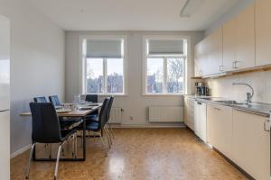 a kitchen with a table and chairs in a room at Functional and Spacious Apartment in Kopparberg in Kopparberg