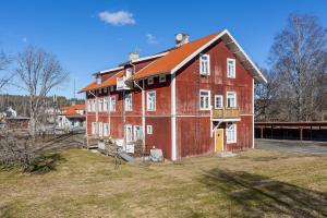 a large red house with a red roof at Functional and Spacious Apartment in Kopparberg in Kopparberg