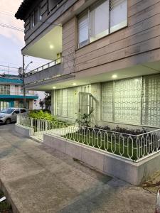 a building with a fence in front of it at Loft 4 Bambú in Laureles Stadium in Medellín